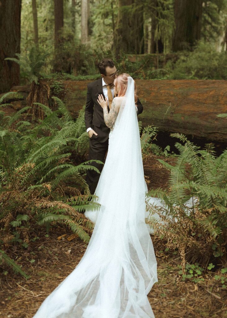 bride and groom taking wedding photos for their forest elopement 