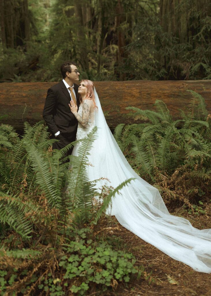 bride and groom taking wedding photos for their forest elopement 