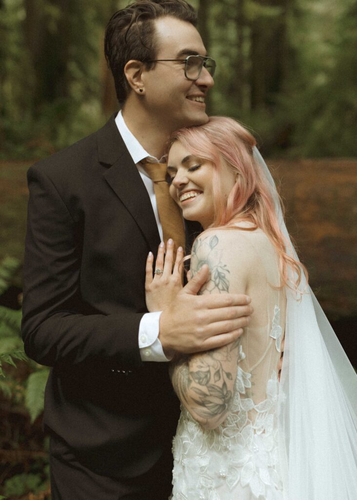 bride and groom taking wedding photos for their forest elopement 