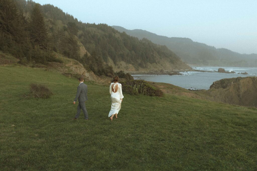 couple walking on the cliffside for their oregon elopement 