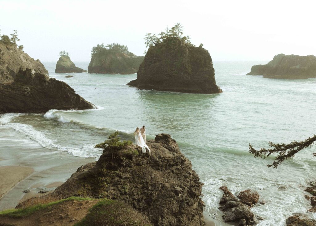 couple walking on the rocks for their oregon elopement 