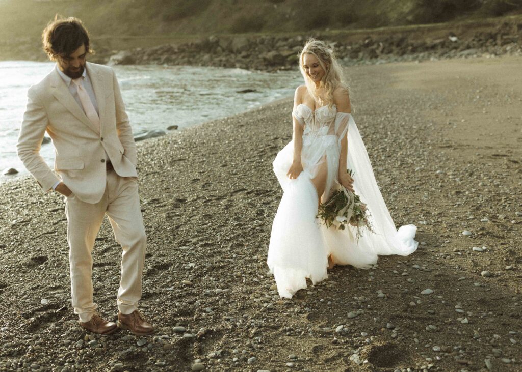 couple walking on the beach for their oregon elopement 