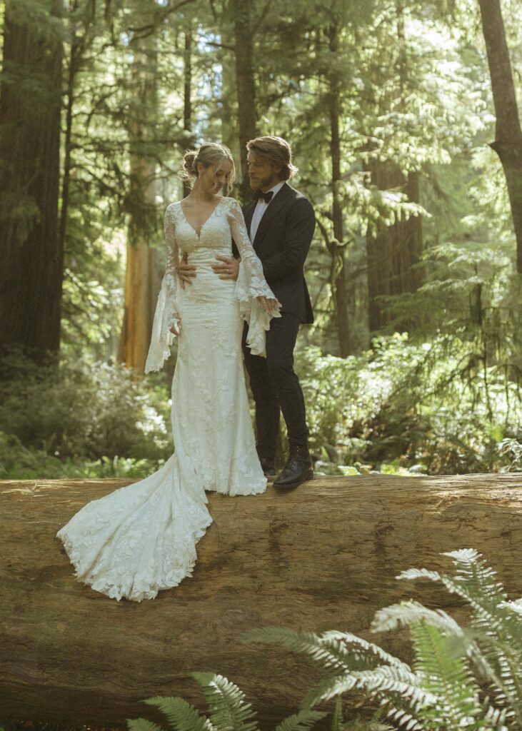 couple taking photos in the Redwoods for their Redwoods Oregon elopement 