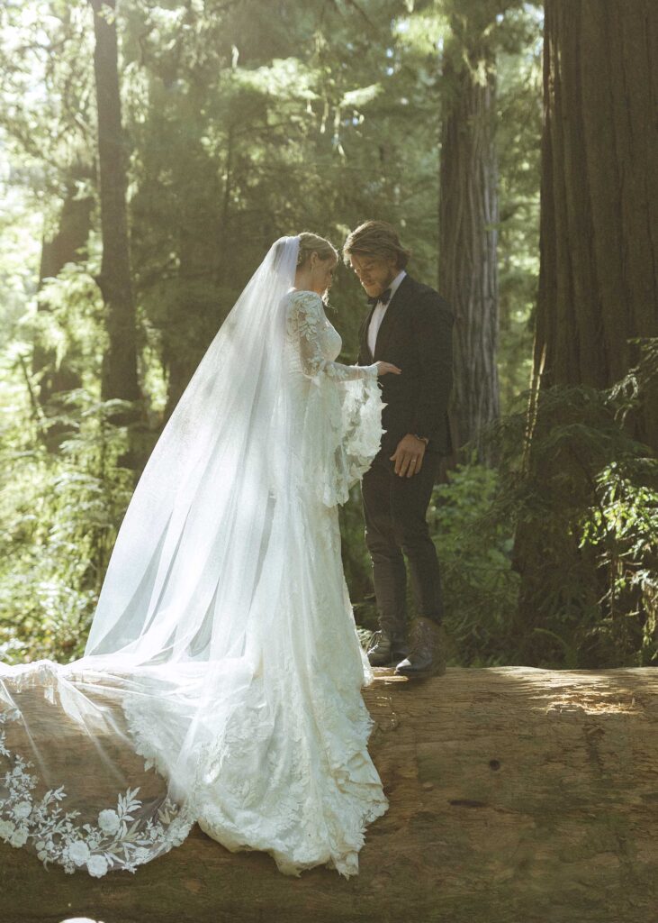 couple taking photos in the Redwoods for their Redwoods Oregon elopement 