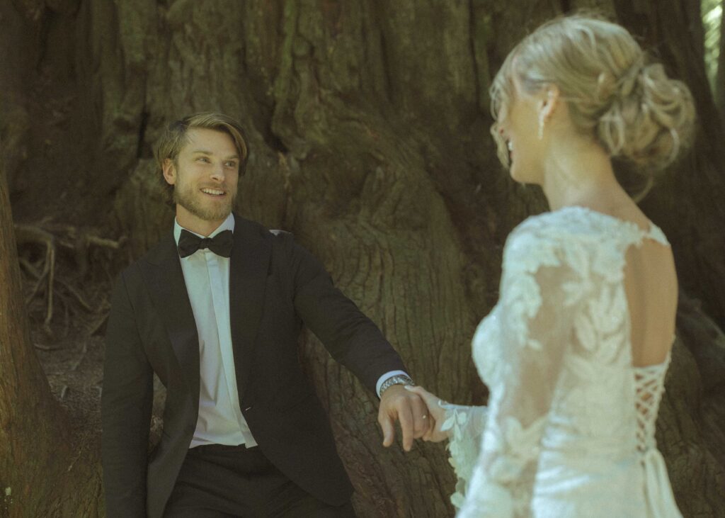 couple taking photos in the Redwoods for their Redwoods Oregon elopement 