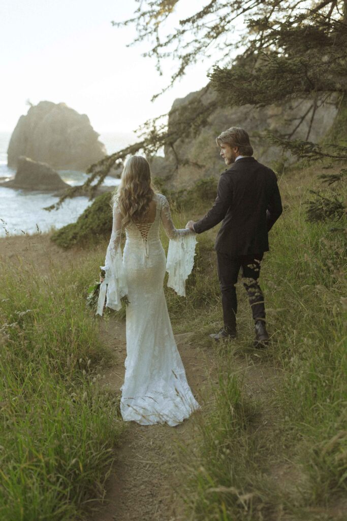 couple taking photos on the beach for their Redwoods Oregon elopement 