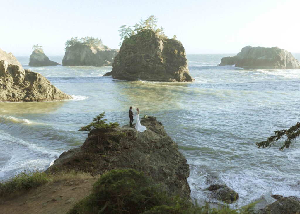 couple taking photos on the beach for their Redwoods Oregon elopement 