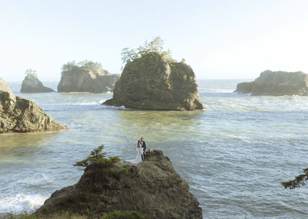 couple taking photos on the beach for their Redwoods Oregon elopement 