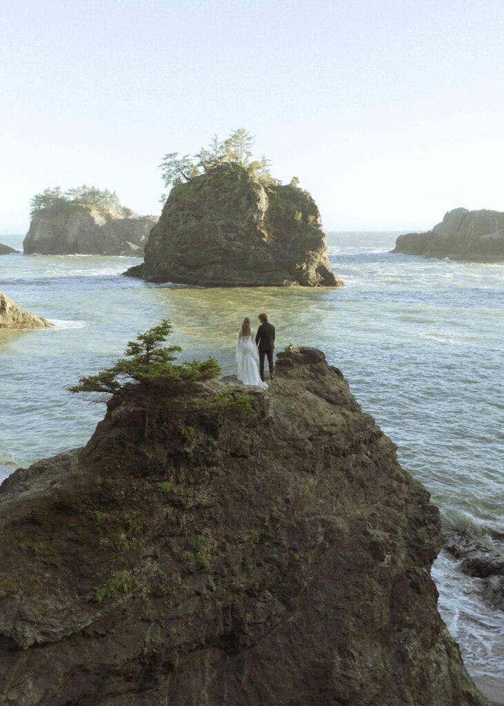 couple taking photos on the beach for their Redwoods Oregon elopement 