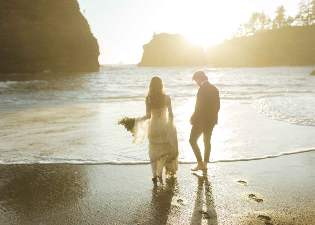 couple walking on the beach for their Redwoods Oregon elopement 