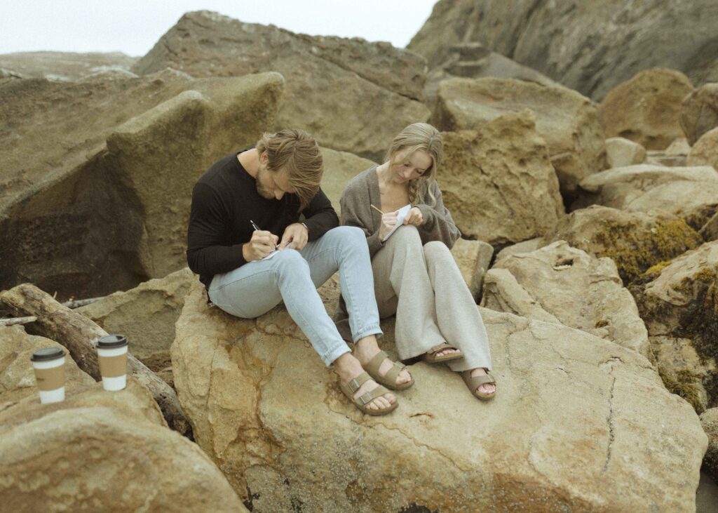 couple writing vows on the beach for their Redwoods Oregon elopement 