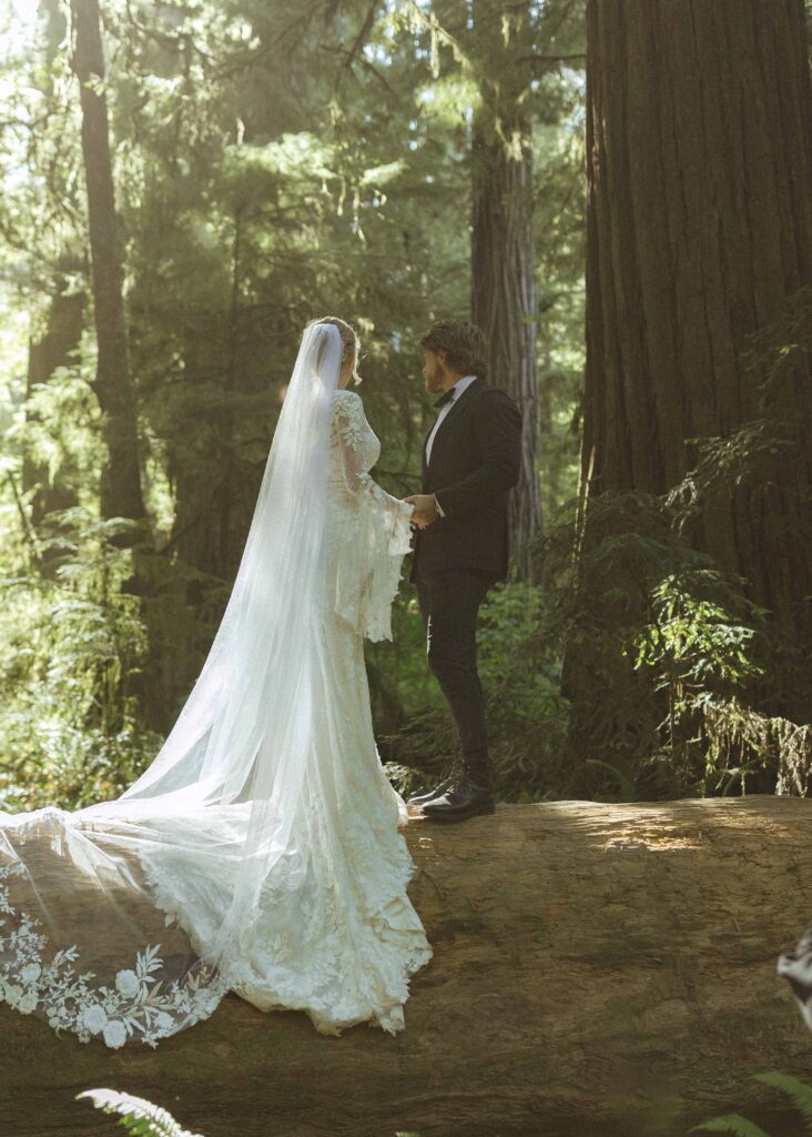 couple taking photos for their redwoods wedding 