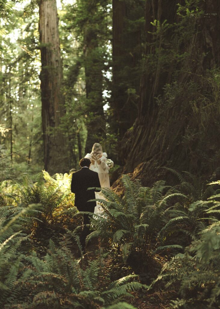 couple taking photos for their redwoods wedding 