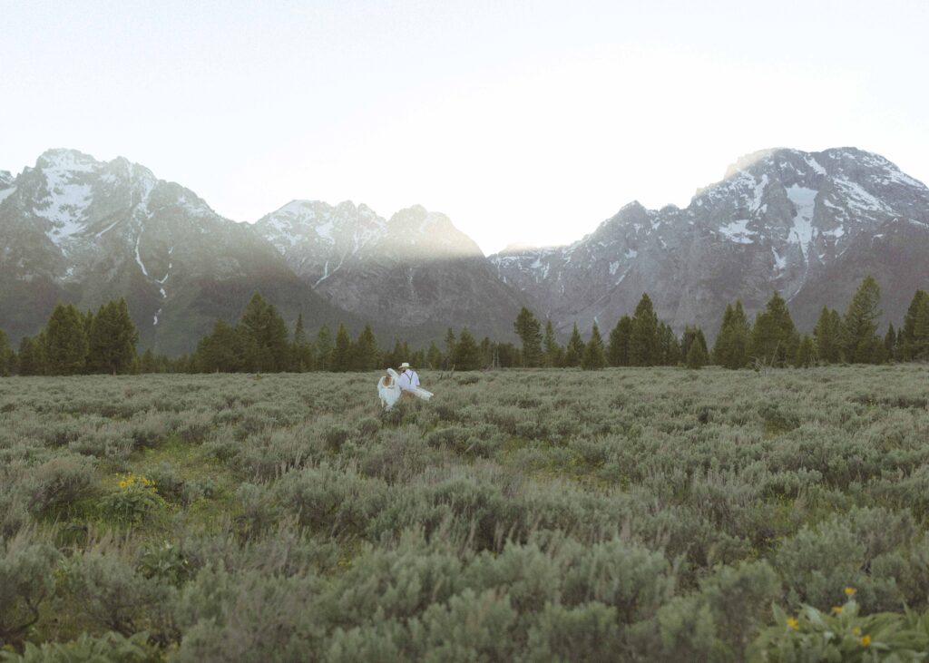 couple taking sunset photos for their Grand Tetons wedding