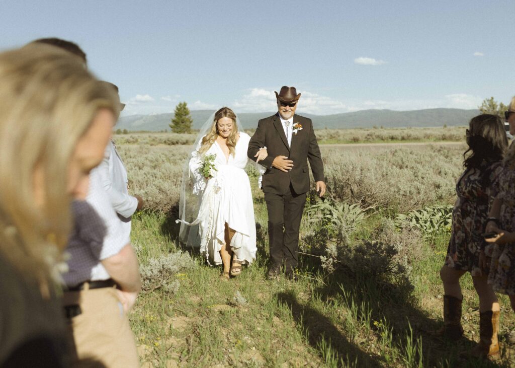 bride walking down the aisle to legally getting married in the Grand Tetons  