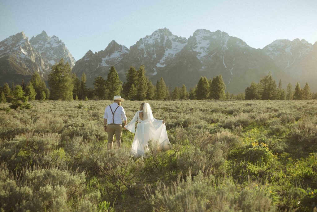 couple taking sunset photos for their Grand Tetons wedding