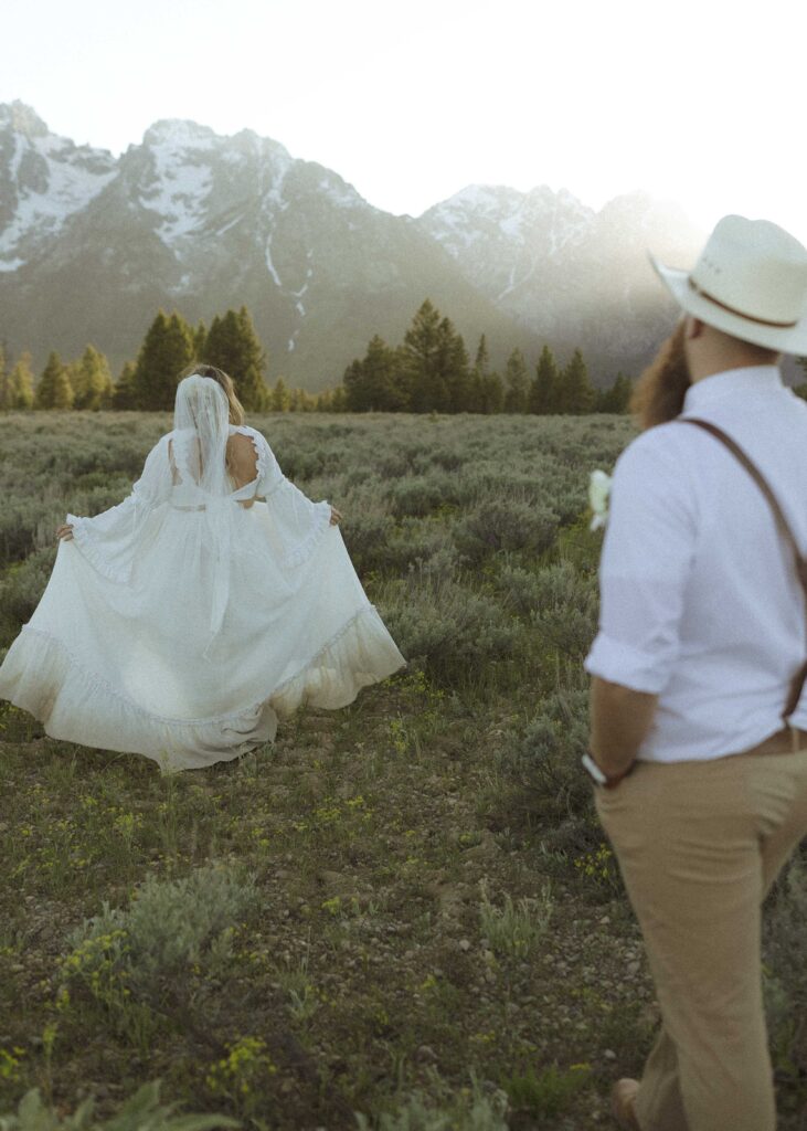 couple taking sunset photos for their mountain view turnout wedding