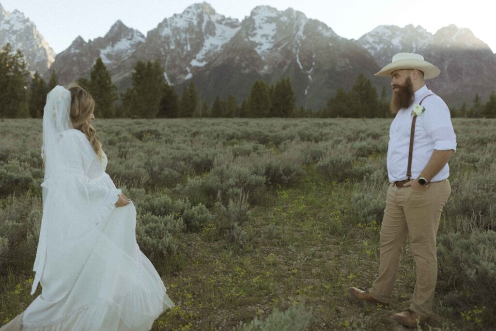 couple taking sunset photos for their mountain view turnout wedding