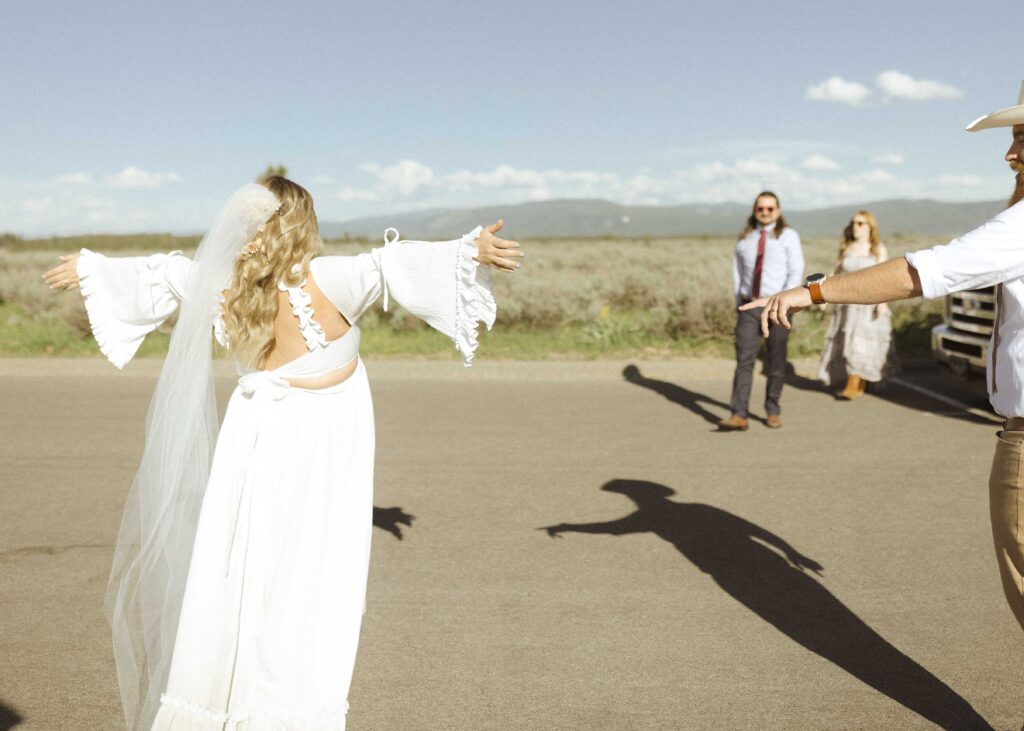 couple greeting guest for their mountain view turnout wedding 