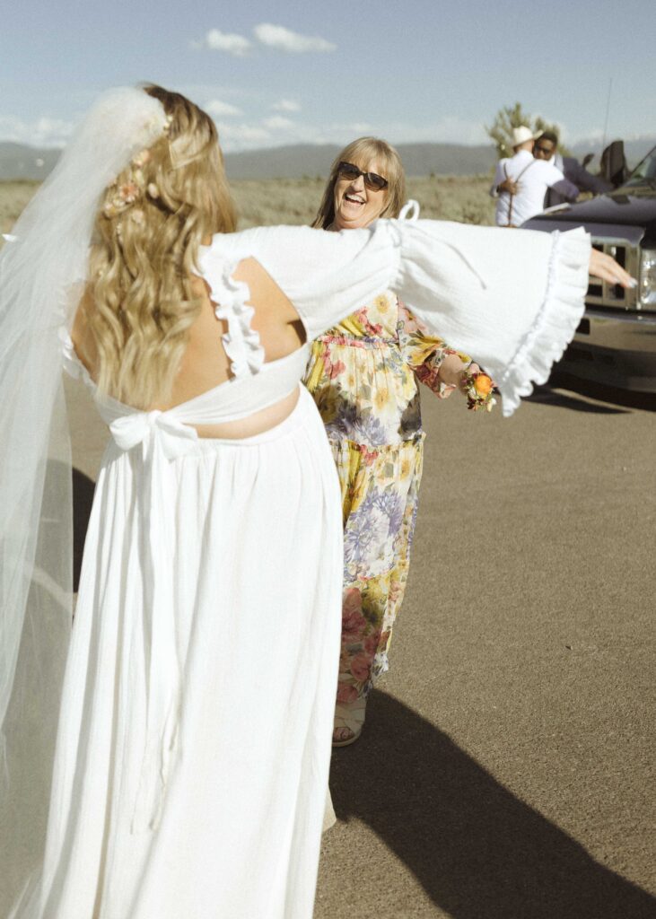 couple greeting guest for their mountain view turnout wedding 