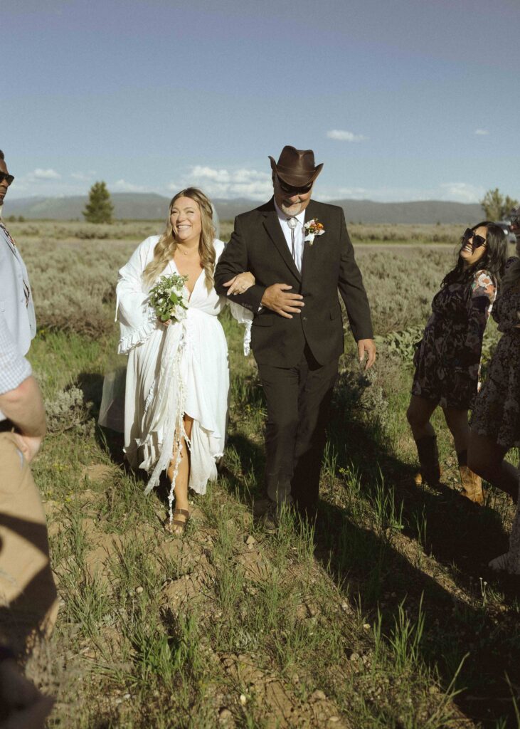 bride walking down the aisle for her mountain view turnout wedding 