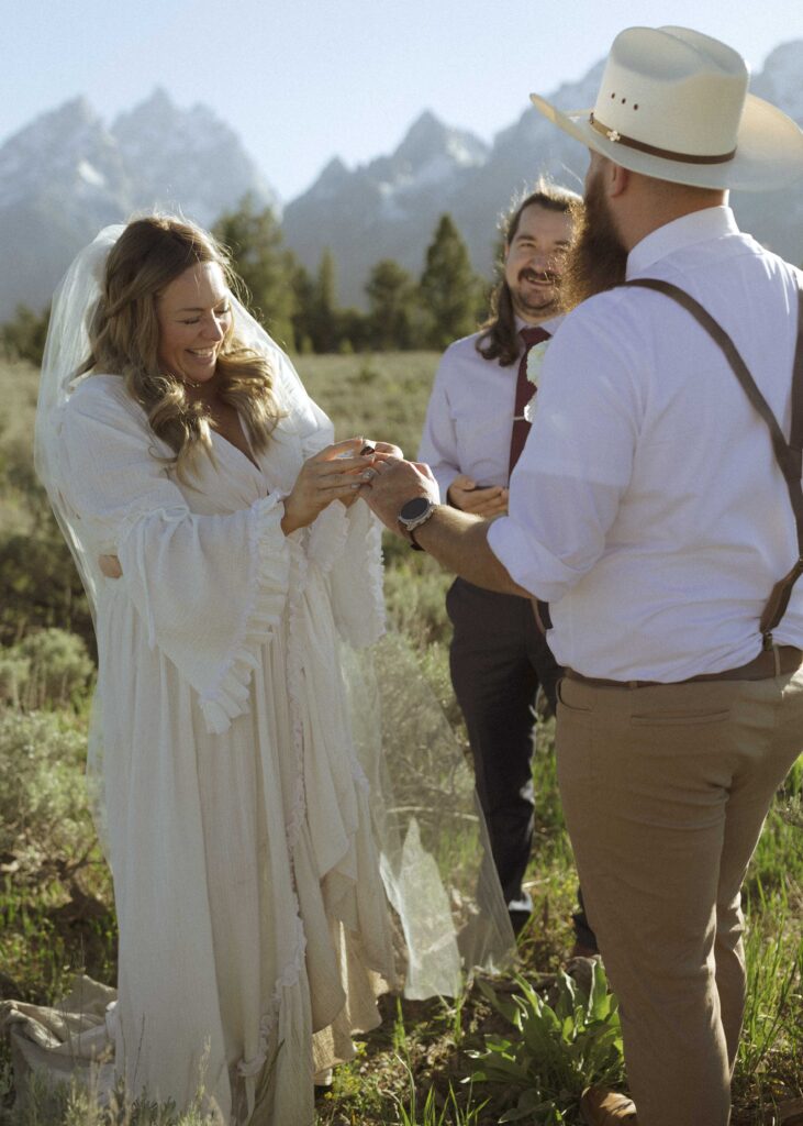 couple exchanging rings for their mountain view turnout wedding 