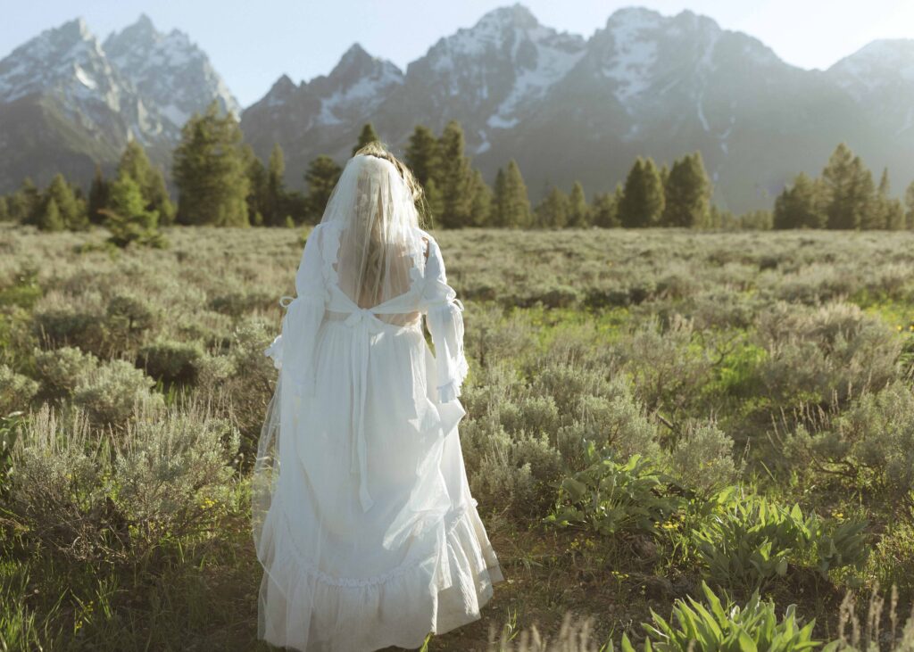 bride taking sunset photos for their mountain view turnout wedding