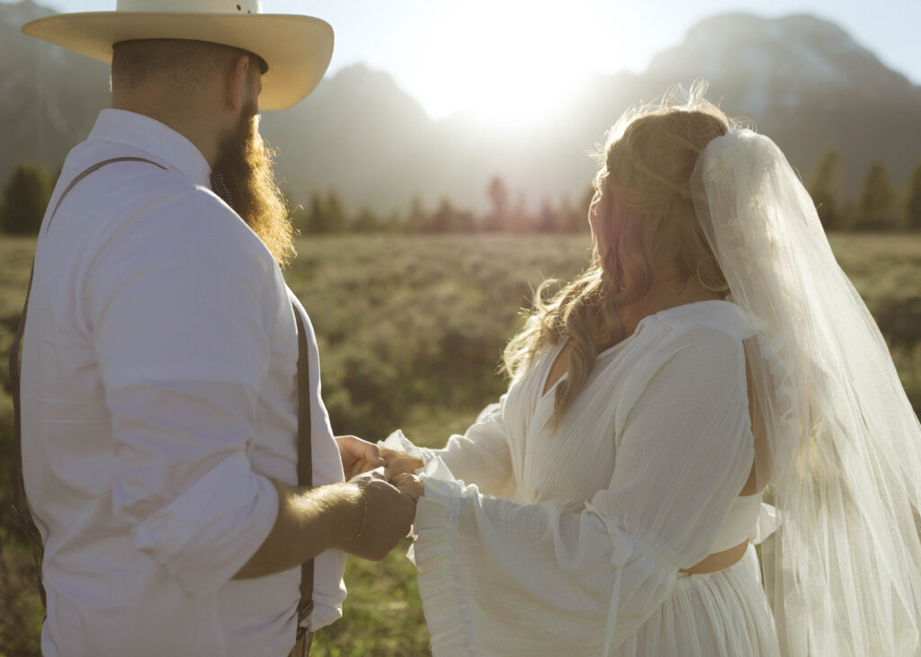 couple taking sunset photos for their mountain view turnout wedding