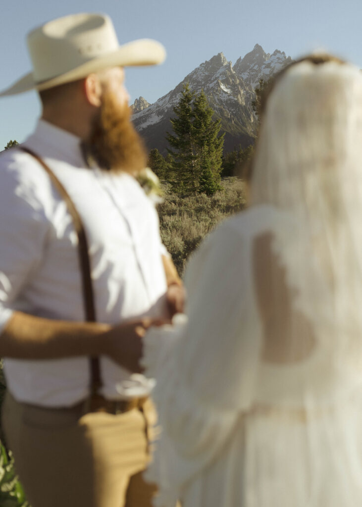 couple taking sunset photos for their mountain view turnout wedding