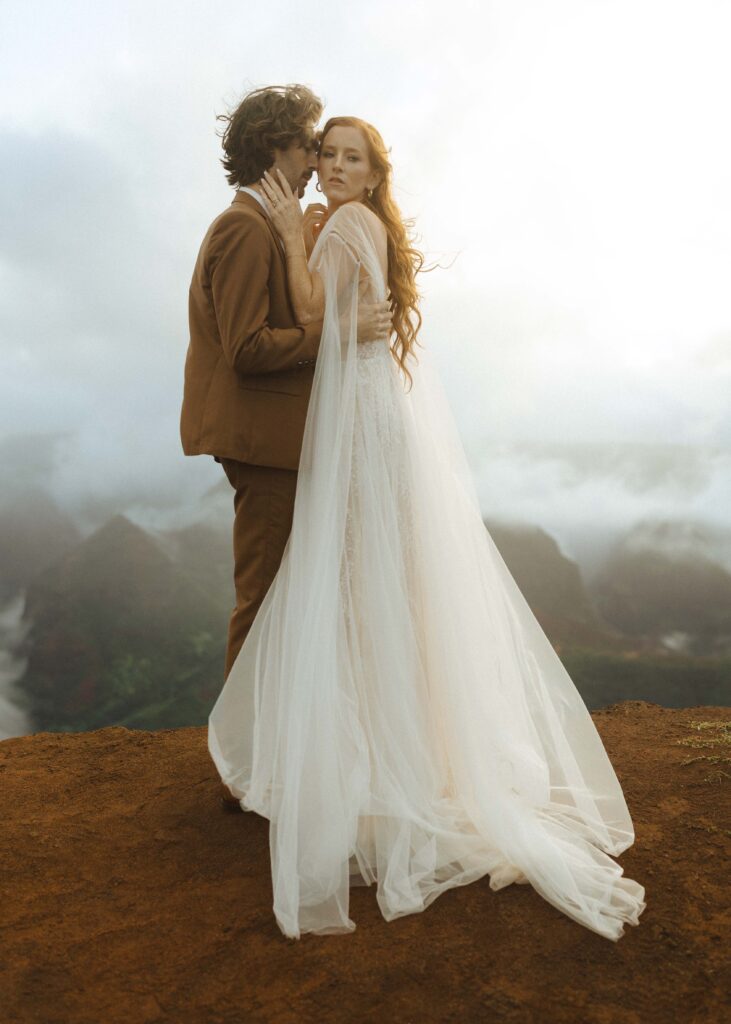 couple walking on waimea canyon for their Kauai elopement 