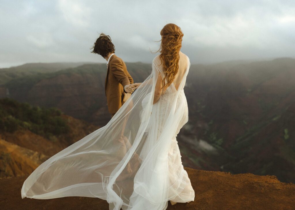 couple walking on waimea canyon for their Kauai elopement 