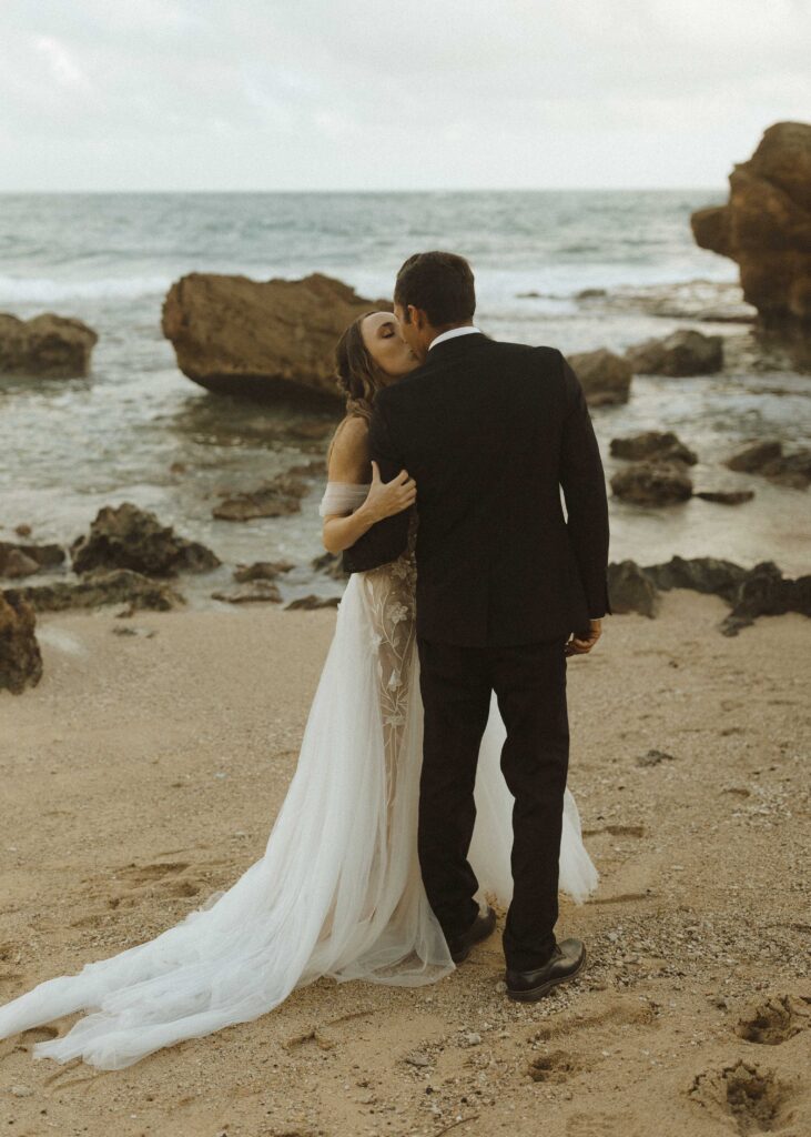 couple walking on the beach for their Kauai elopement 