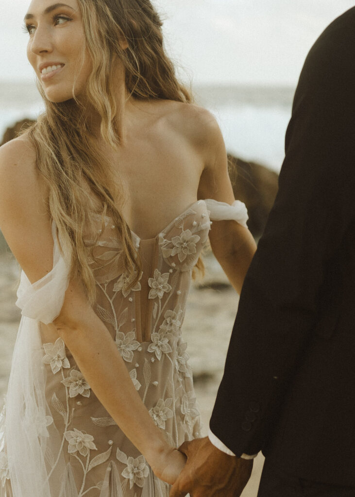 couple walking on the beach for their Kauai elopement 