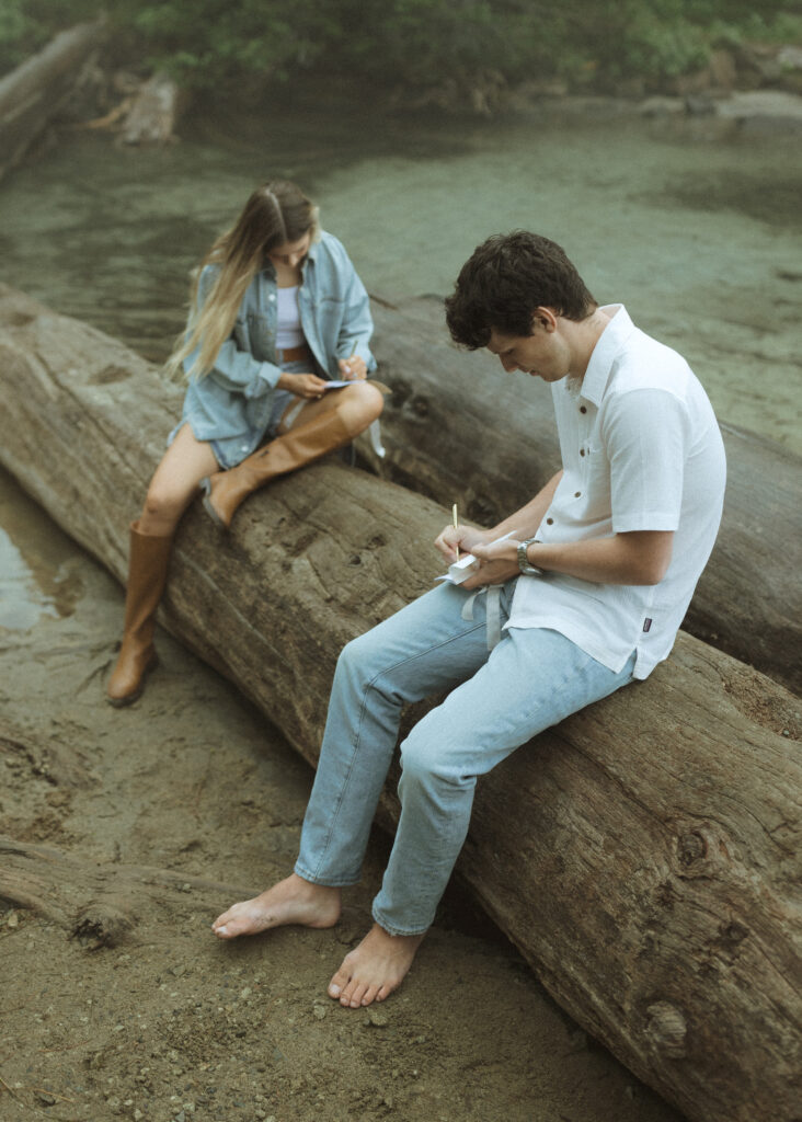 bride and groom writing their vows for their Mowich Lake Elopement in Mt. Rainier National Park 