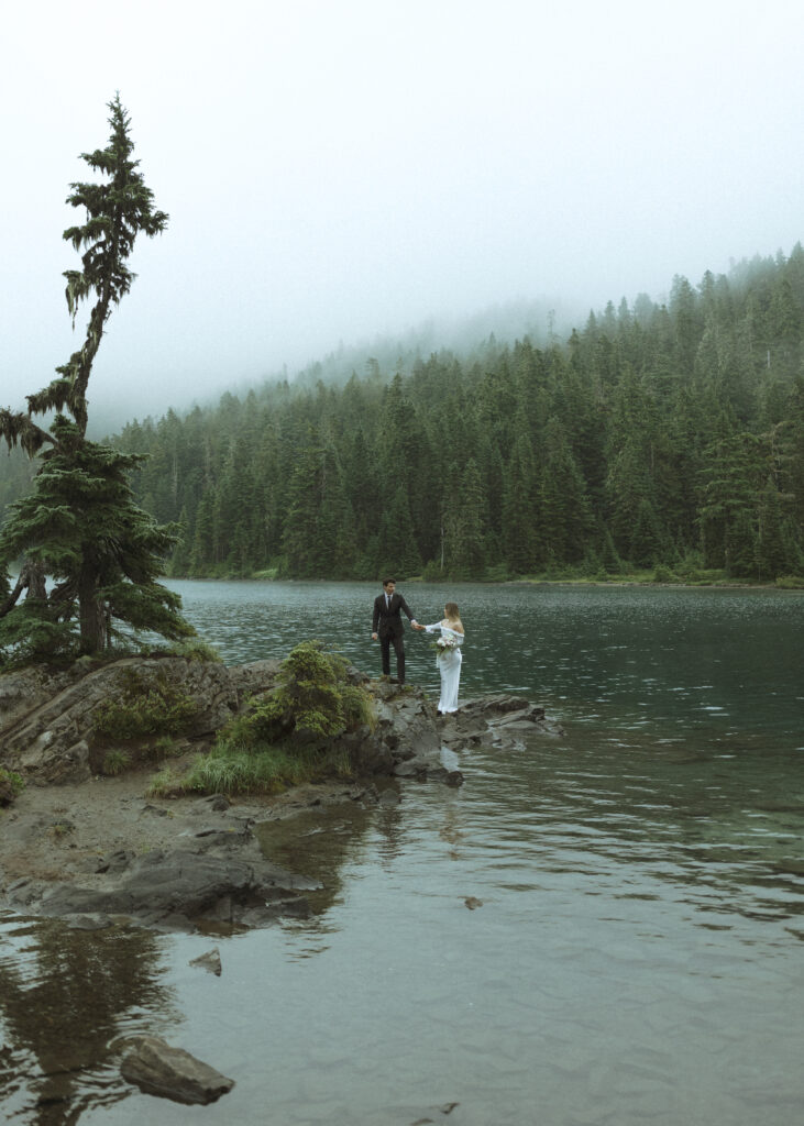 bride and groom taking photos for their Mowich Lake Elopement in Mt. Rainier National Park 