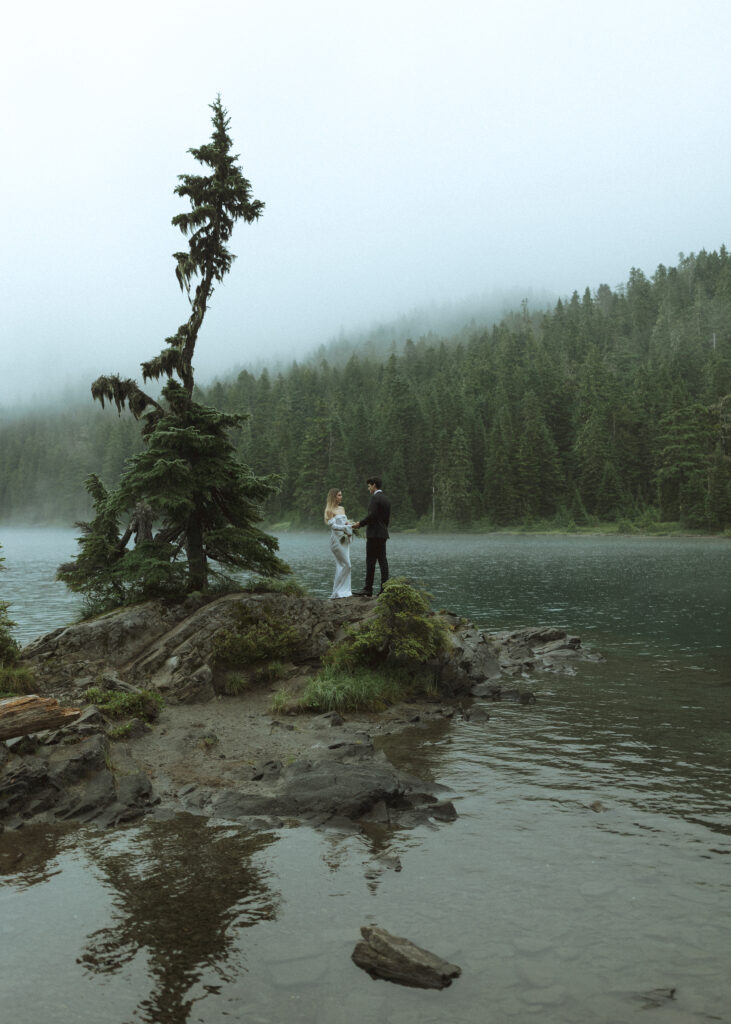 bride and groom taking photos for their Mowich Lake Elopement in Mt. Rainier National Park 