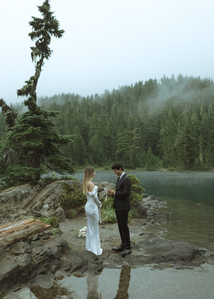 bride and groom reading their vows for their Mowich Lake Elopement in Mt. Rainier National Park 