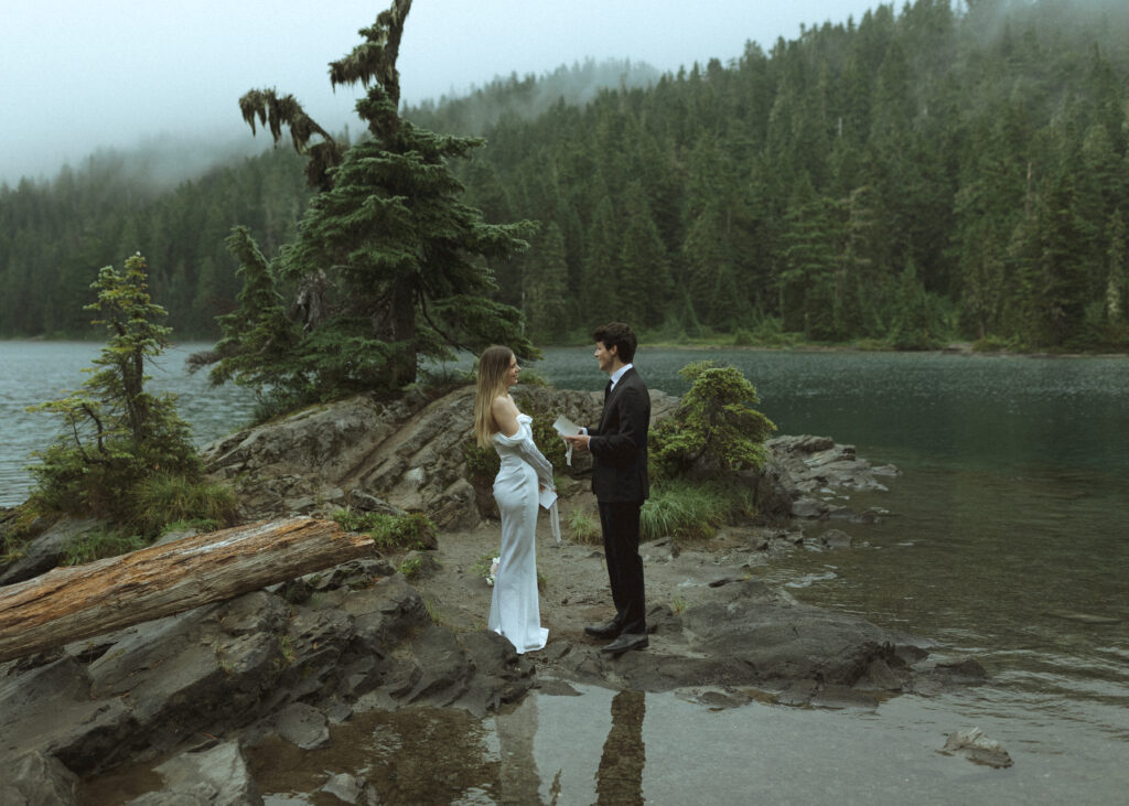 bride and groom reading their vows for their Mowich Lake Elopement in Mt. Rainier National Park 