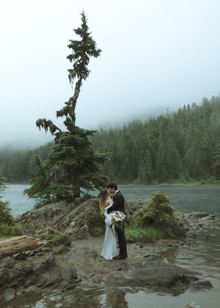 bride and groom taking photos for their Mowich Lake Elopement in Mt. Rainier National Park 