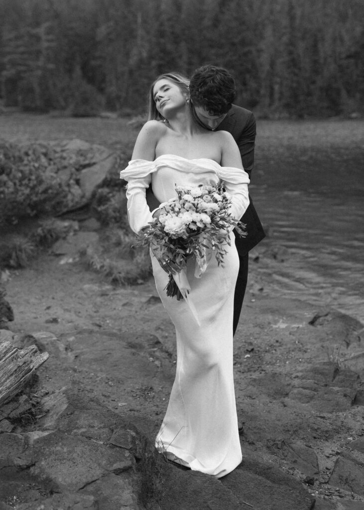 bride and groom taking photos for their Mowich Lake Elopement in Mt. Rainier National Park 