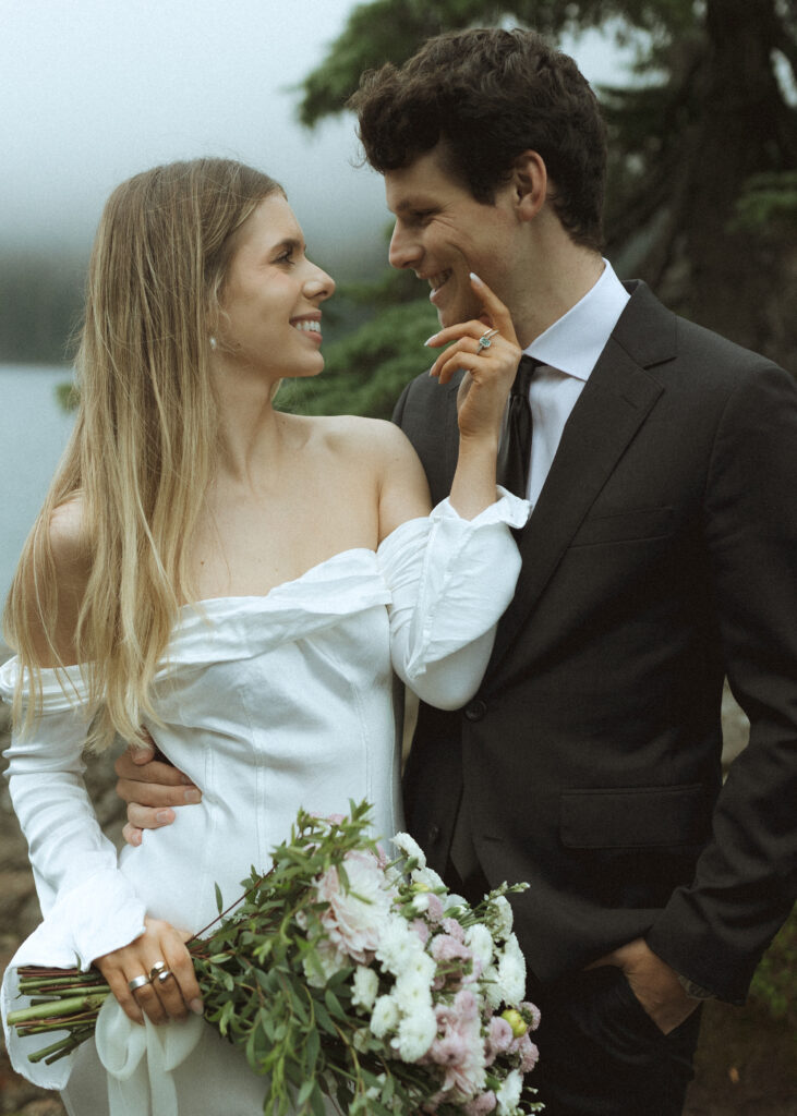 bride and groom taking photos for their Mowich Lake Elopement in Mt. Rainier National Park 