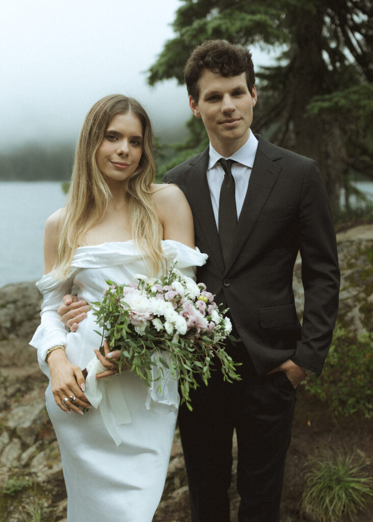 bride and groom taking photos for their Mowich Lake Elopement in Mt. Rainier National Park 