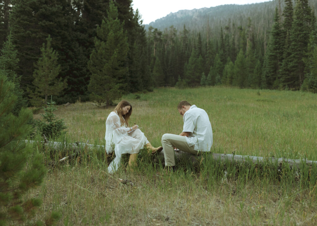 couple writing letters for their anniversary photos at Rocky Mountain National Park 