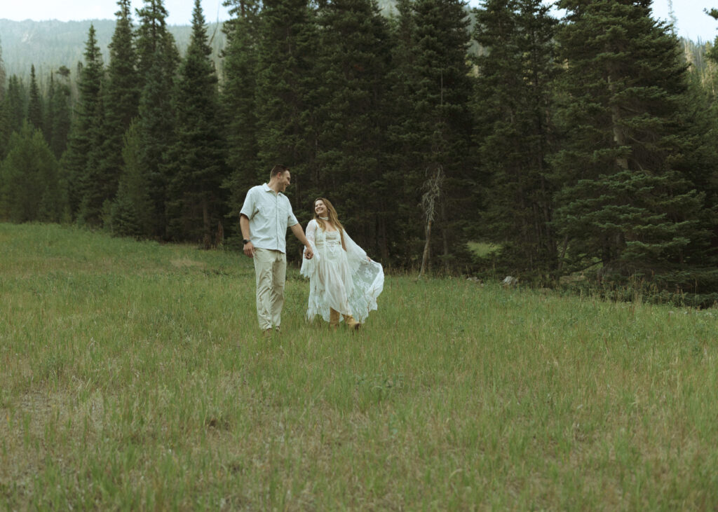 couple walking for their anniversary photos at Rocky Mountain National Park 