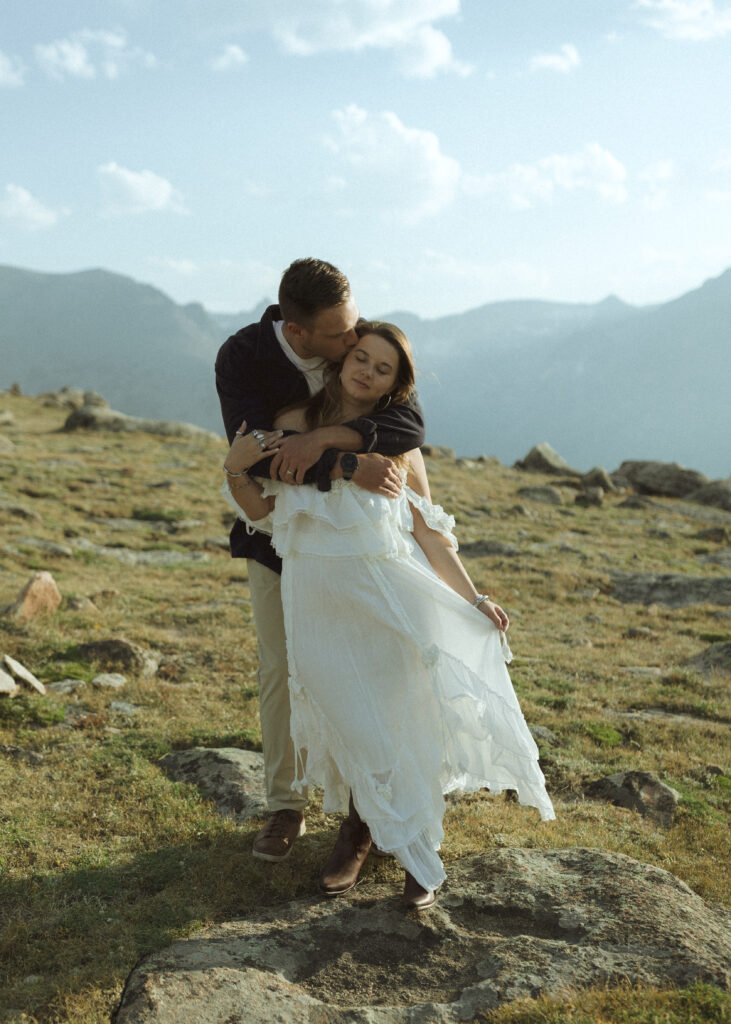 couple posing for their anniversary photos at Rocky Mountain National Park 