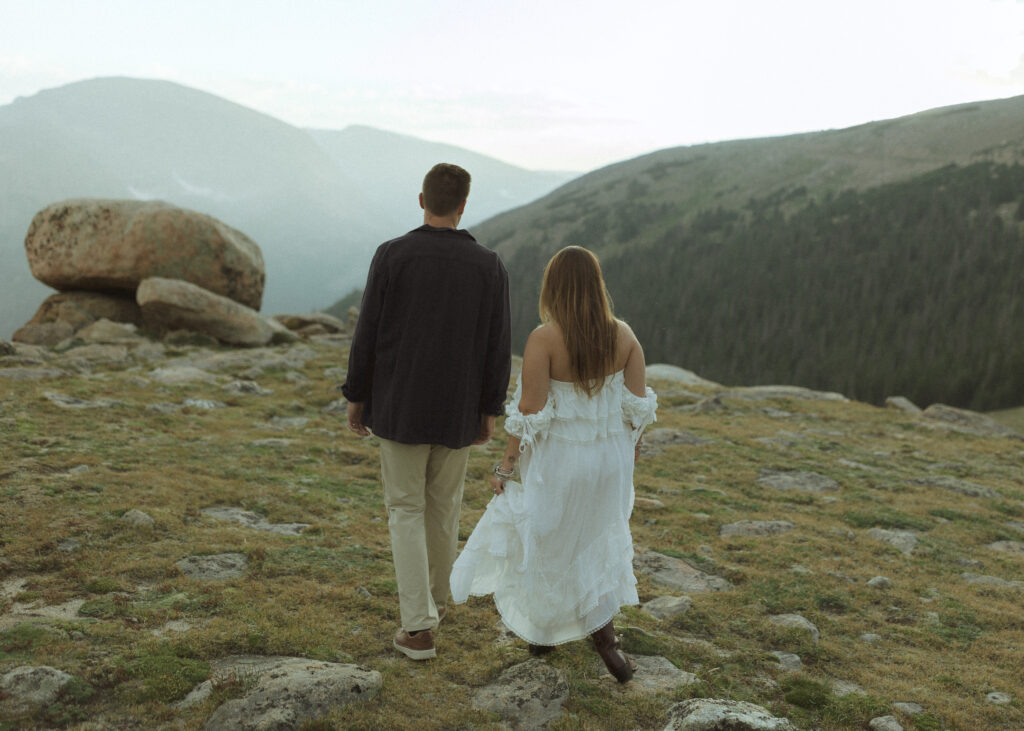 couple walking for their anniversary photos at Rocky Mountain National Park 