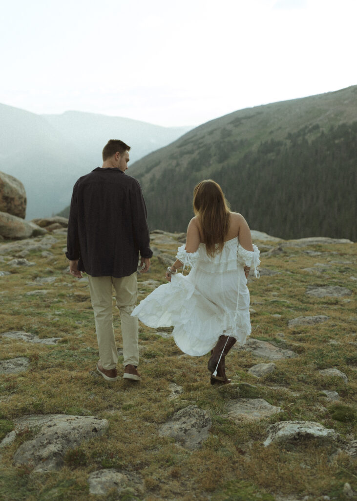 couple walking for their anniversary photos at Rocky Mountain National Park 