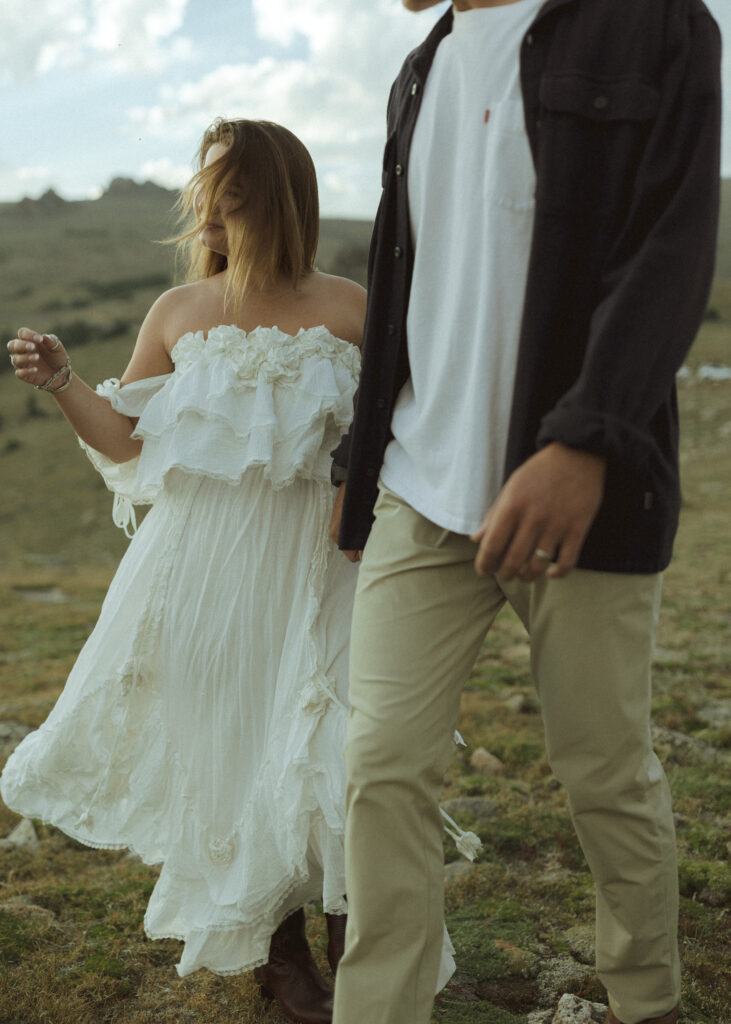 couple walking for their anniversary photos at Rocky Mountain National Park 