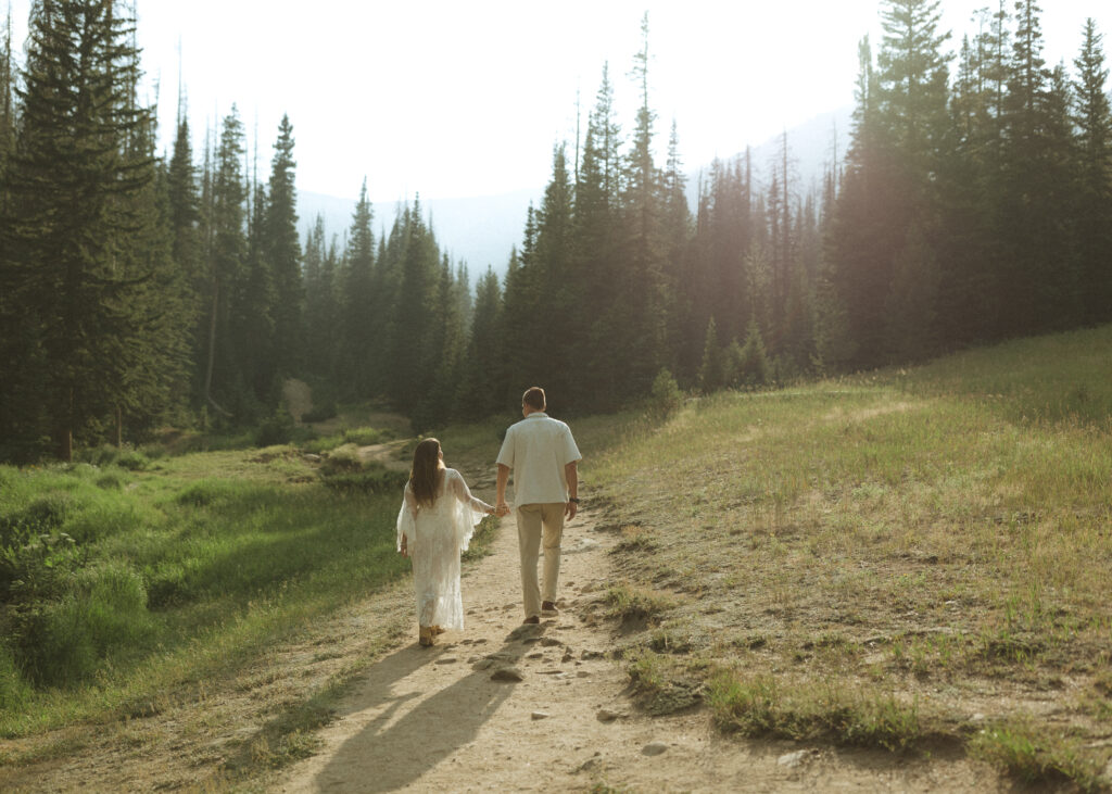 couple walking for their anniversary photos at Rocky Mountain National Park 