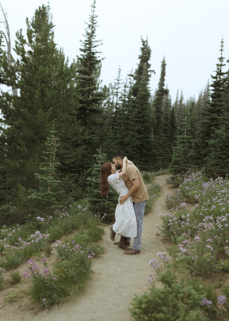 bride and groom taking photos in their casual outfit for their silver forest trail elopement 